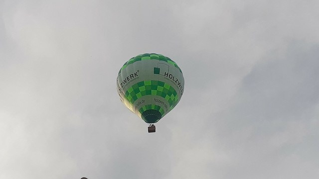 Fesselballon (grün/hellgrün/weiss) relativ kurz vor der Landung.
In Celle ansässige Zimmerei Holzwerk betreibt 3-4 Fesselballons, ist auch regelmäßig im Ausland unterwegs.