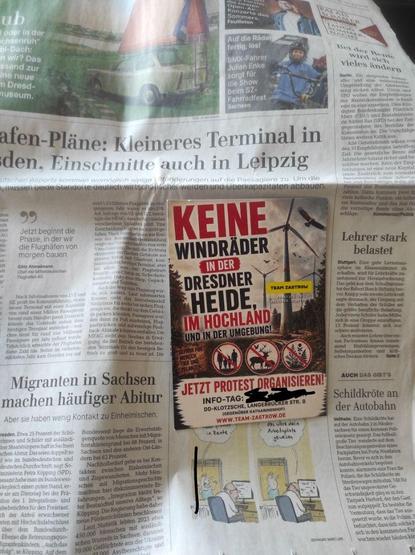 Bild der Titelseite der Sächsischen Zeitung mit einem darauf klebenden Werbeflyer für eine Antiwindkraftvetanstaltung von Team Zastrow. 
