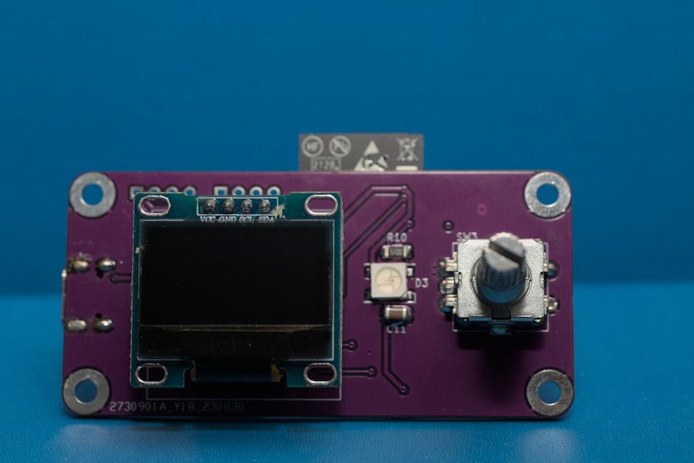 The front of the violet colored PCB with the display and the knob.