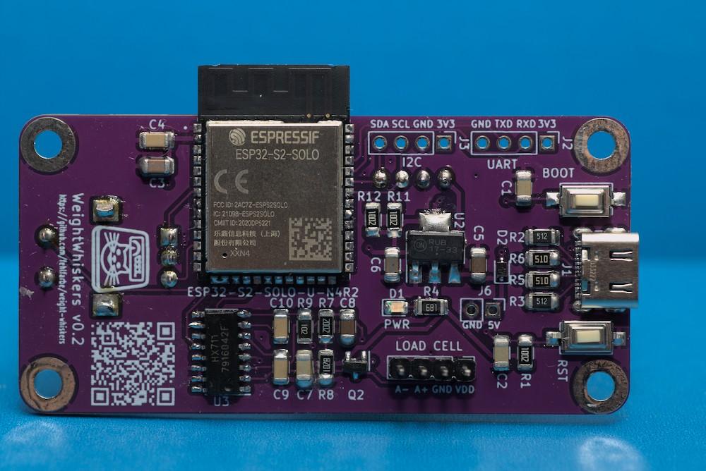 The back of the violet colored PCB with the ESP32 S2 controller, some additional parts and a logo and QR code to the project's Github page